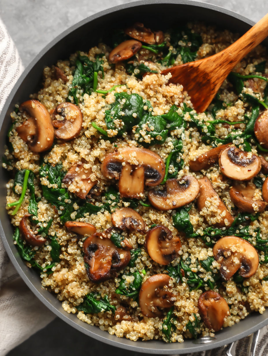 A skillet full of mushrooms and spinach.