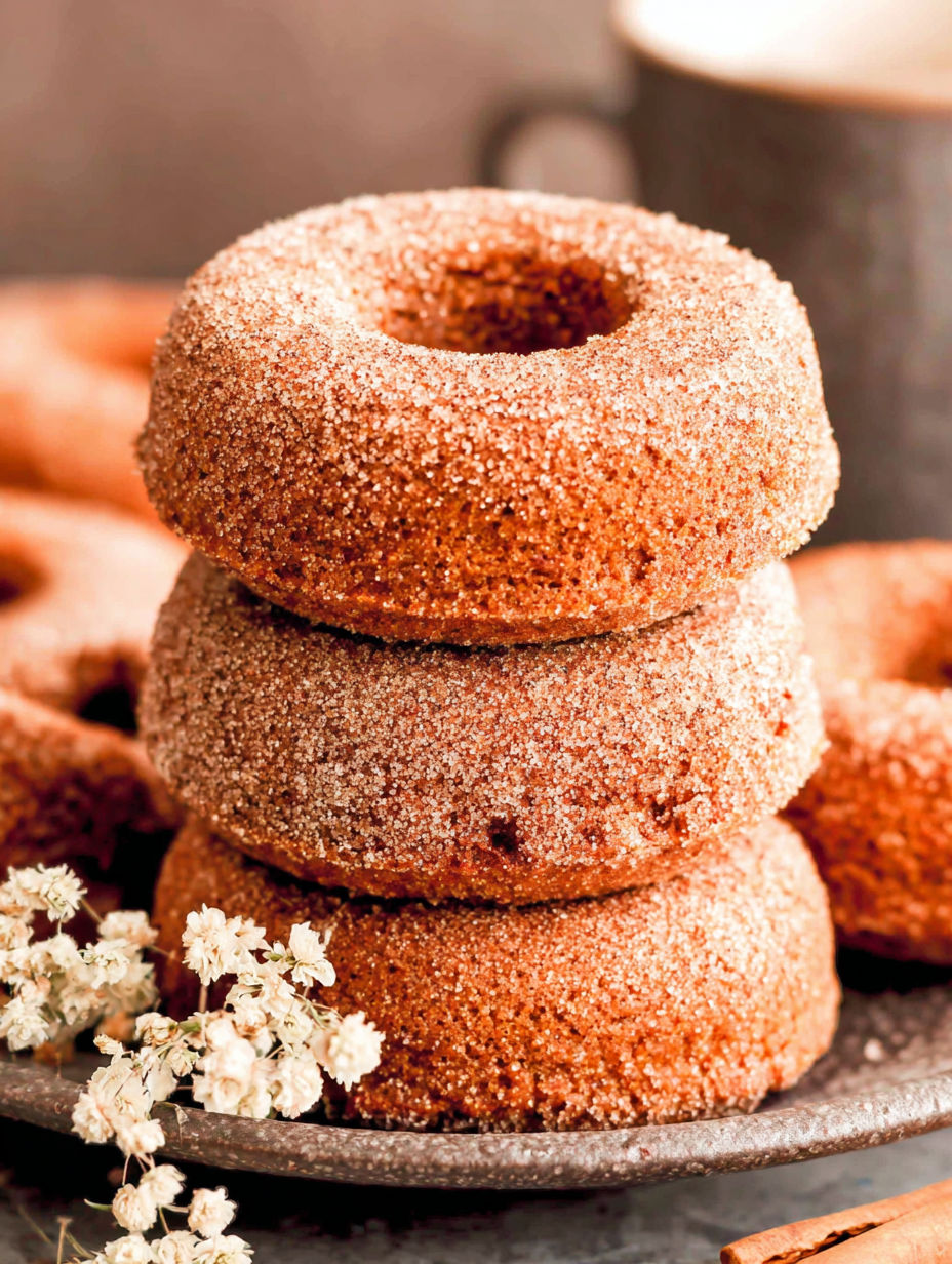 Pumpkin spice baked donuts stacked on top of each other.