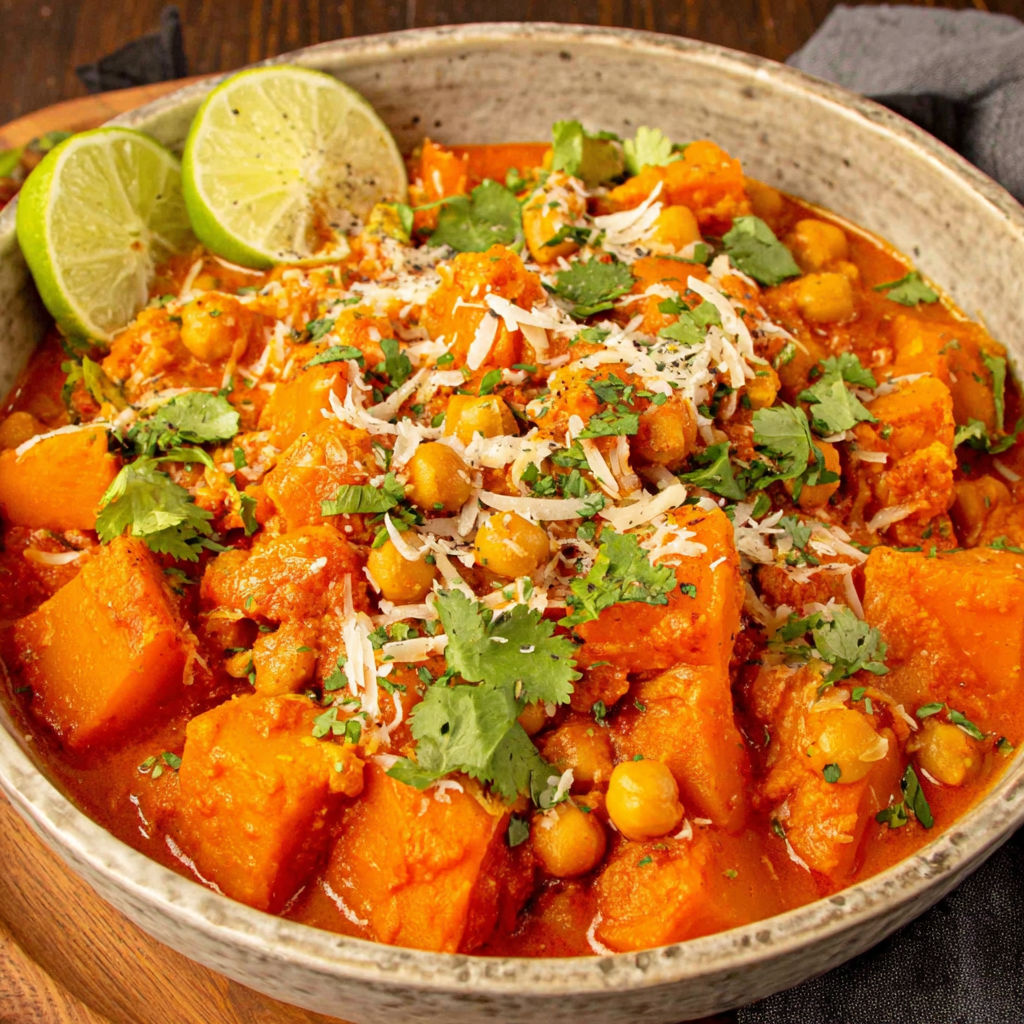 A bowl of pumpkin curry with chickpeas and coconut.