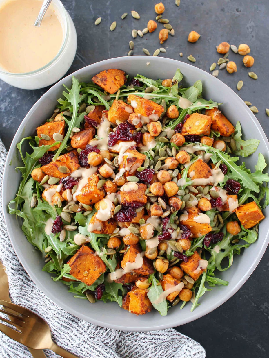 A bowl of roasted chickpea and sweet potato salad with sweet tahini dressing.