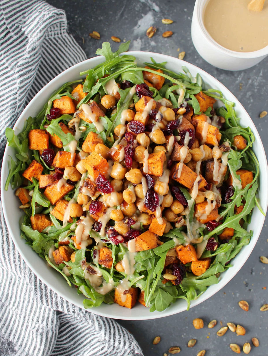 A bowl of roasted chickpea and sweet potato salad with sweet tahini dressing.