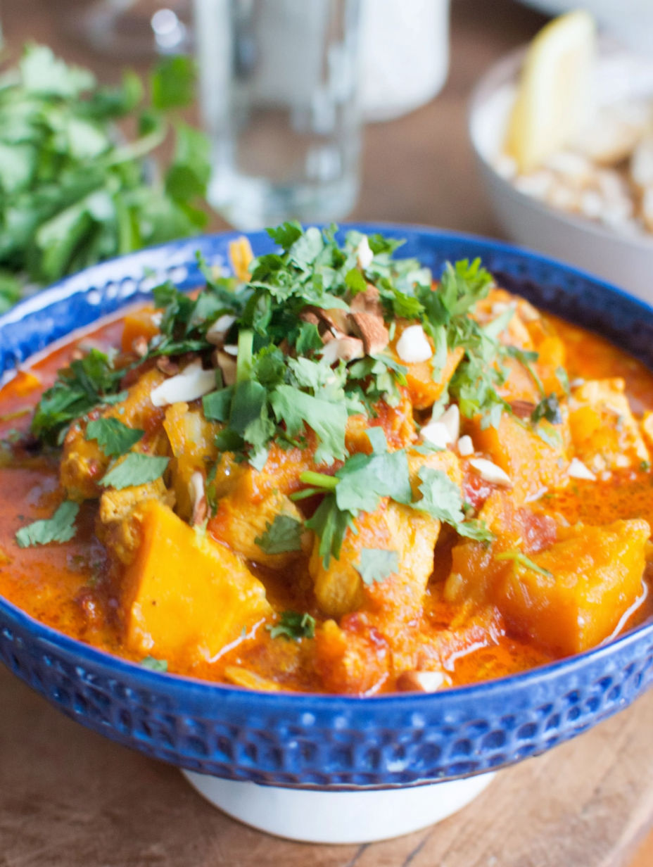 A bowl of chicken and butternut squash curry.