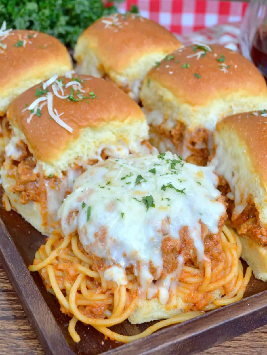 A plate of spaghetti sliders with cheese.