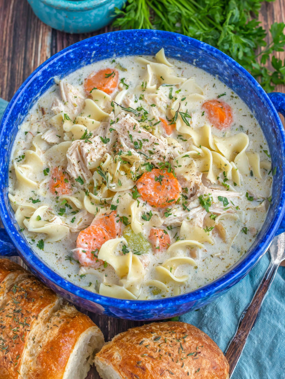 A bowl of creamy chicken noodle soup.
