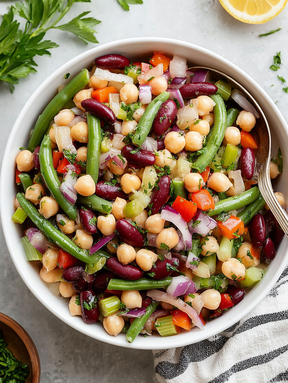 A bowl of food with chickpeas, onions, and carrots.