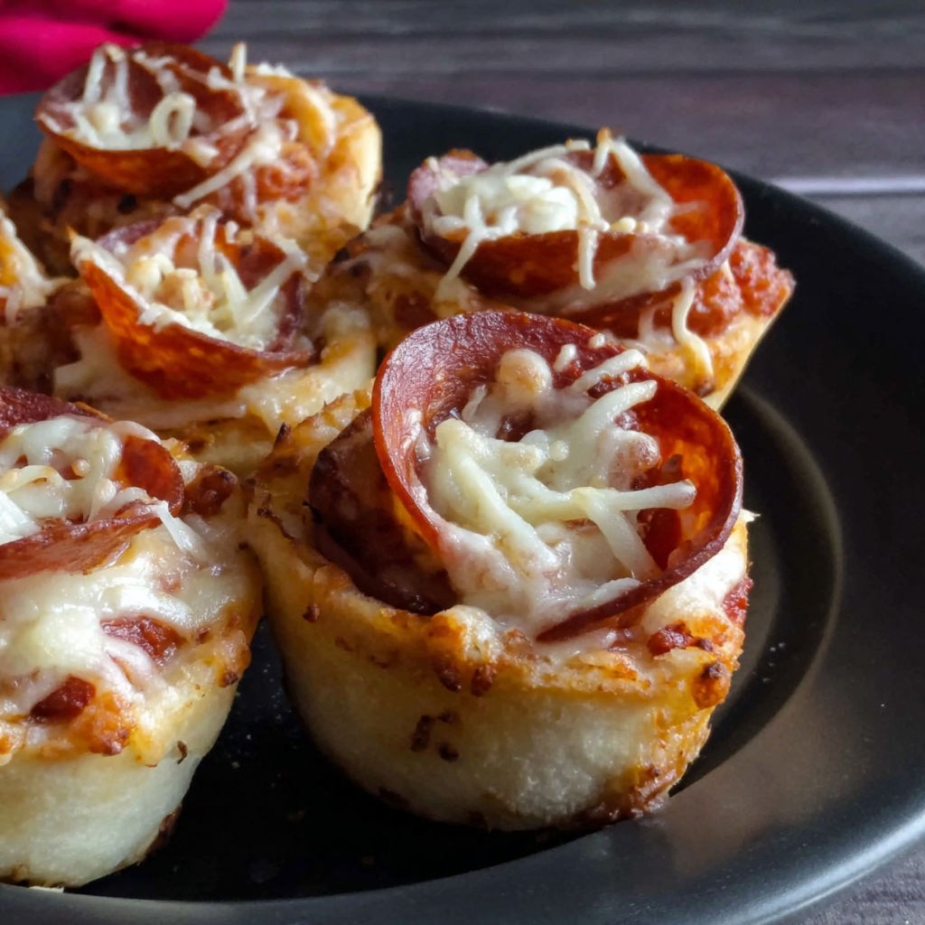 A plate of pizza with cheese and pepperoni.
