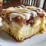 A slice of cinnamon roll poke cake.