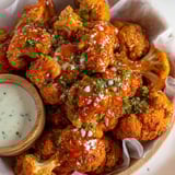A bowl of crispy buffalo cauliflower bites.