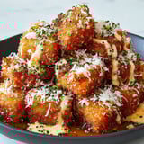 A plate of crispy bang bang salmon bites.