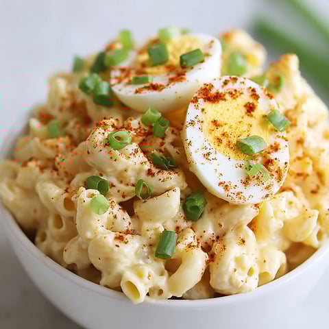 A bowl of pasta with eggs and peppers.