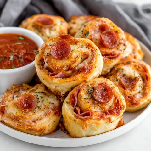 A plate of pepperoni pizza rolls.
