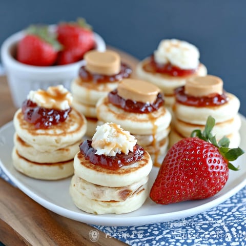 A plate of peanut butter and jelly mini pancakes.