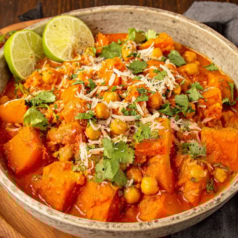 A bowl of pumpkin curry with chickpeas and coconut.