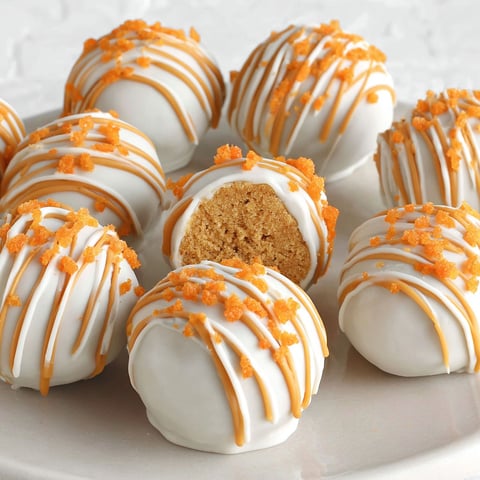 A plate of no-bake pumpkin cheesecake balls.