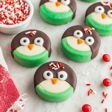 A bowl of green and white cookies.