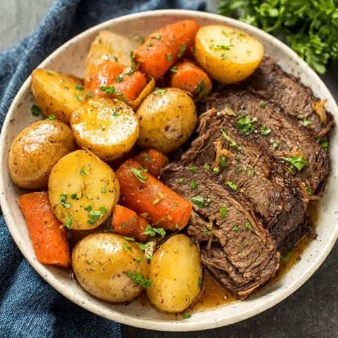 A plate of food with potatoes, carrots, and meat.