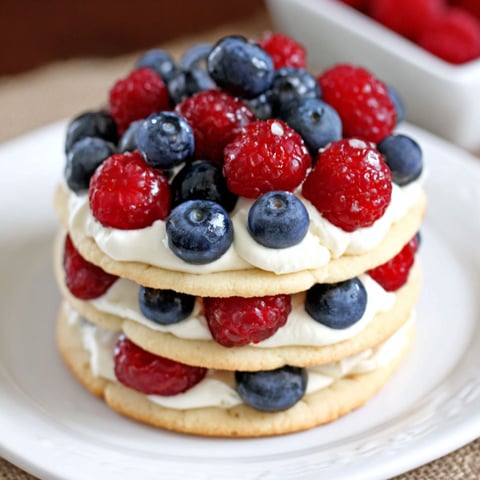 A stack of mini fruit pizza cookies.
