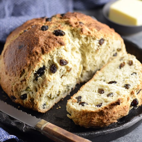 A slice of Irish soda bread with raisins.