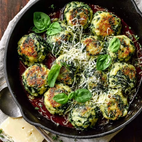 A pan of Malfatti Spinach Ricotta Dumplings with Savory Sage Butter.