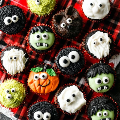 Halloween cupcakes with eyes and mouths.