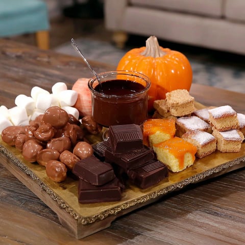 A table with a variety of Halloween candy.