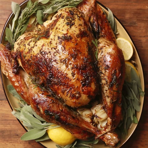 A roasted turkey with herbs and lemon.
