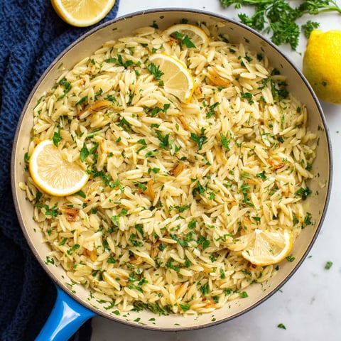 A pan of rice with lemon and herbs.