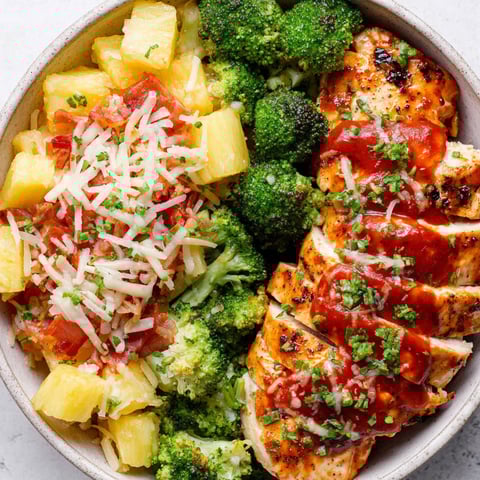 A bowl of chicken and pineapple.