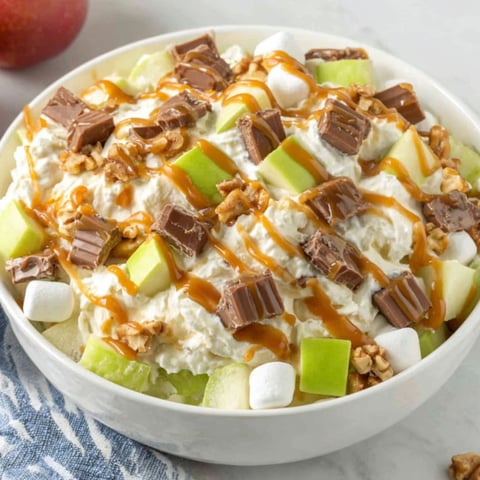 A bowl of Snickers Caramel Apple Salad.