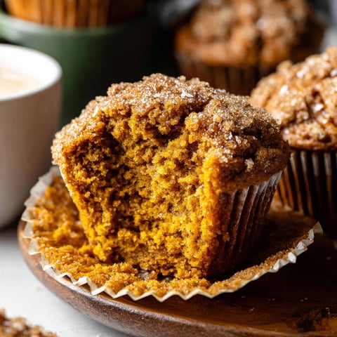 A cupcake with a bite taken out of it.