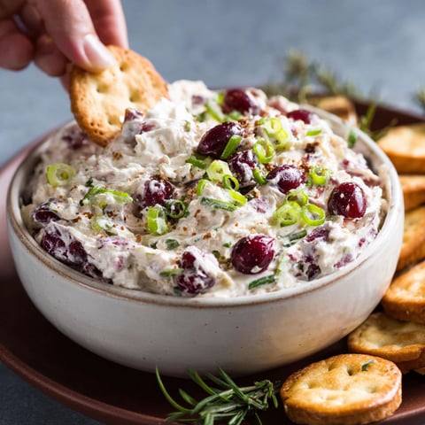 A bowl of cranberry jalapeno cream cheese dip.