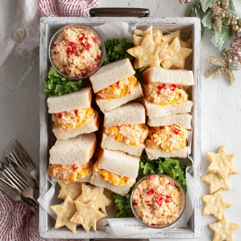 A tray of pimento cheese star sandwich bites.