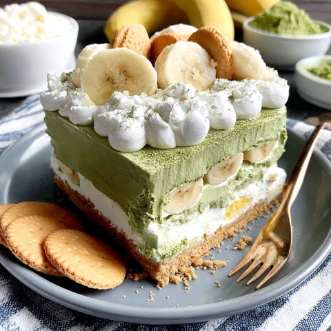 A slice of banana pudding with white whipped cream.